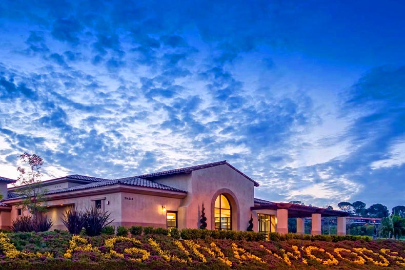 Exterior view of the clubhouse at twilight at Laguna Woods Village in California