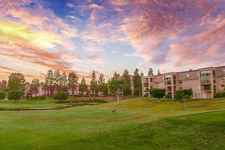 A sunset over a golf course and condo buildings at Laguna Woods Village in Laguna Woods, California