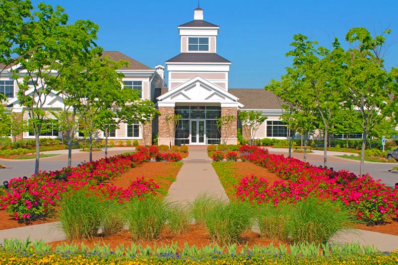 A red and pink garden lining a pathway leading up to the clubhouse in Del Webb Lake Providence, located in Mt. Juliet, Tennessee