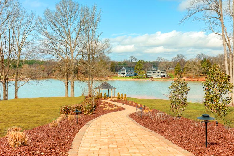 A brick bath to a gazebo on a lake in Lake Walk Freedom Homes of Mooresville, North Carolina