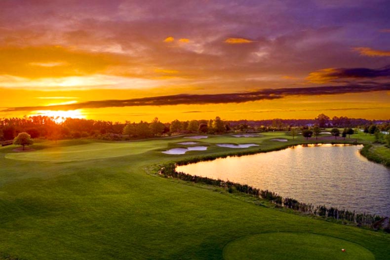 Sunset over a golf course and pond at The Lakes at Harmony in Harmony, Florida