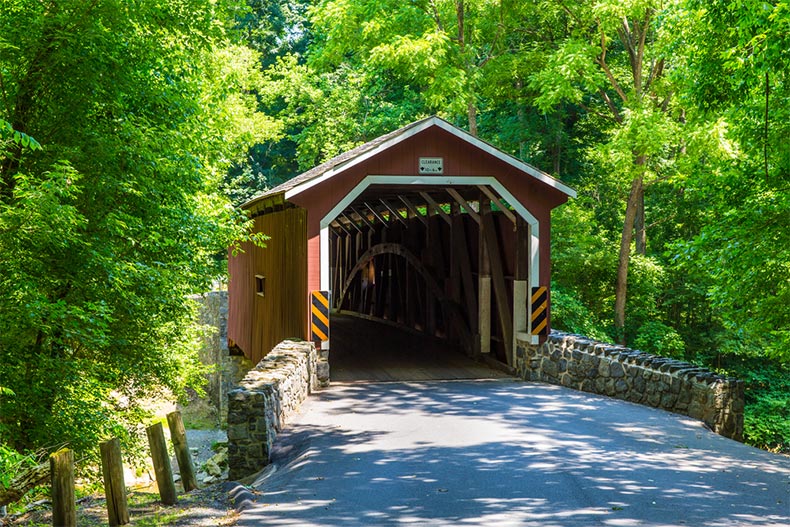 A red covered bridge during summer in Lancaster County, Pennsylvania