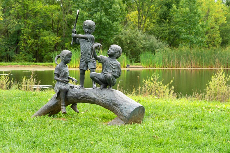 Sculpture of three children on a log at Stony Creek Park in Lansdale, Pennsylvania