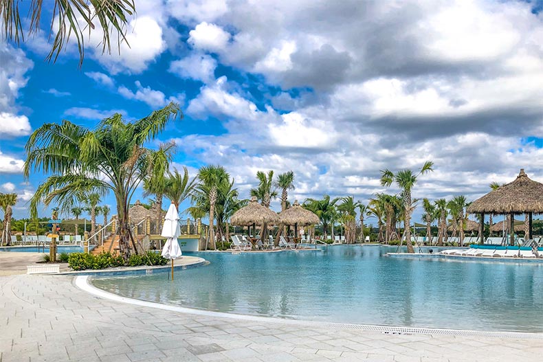 Palm trees and cabanas surrounding the resort-style pool at Latitude Margaritaville in Daytona Beach, Florida