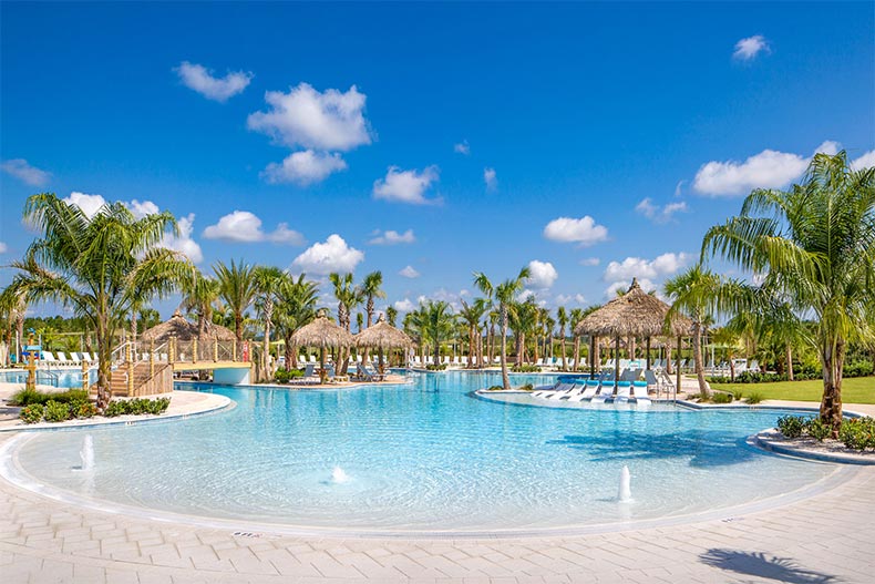 Palm trees and cabanas surrounding the resort-style pool at Latitude Margaritaville in Daytona Beach, Florida