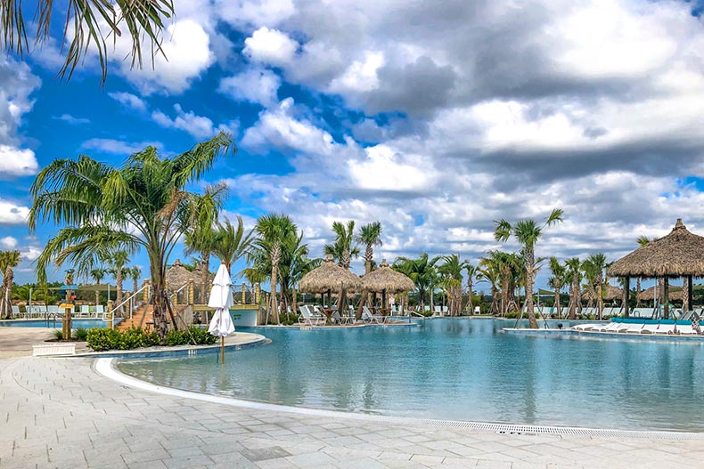 Palm trees, cabanas, and lounge chairs surrounding a zero-entry, resort-style pool at Latitude Margaritaville in Daytona Beach, Florida