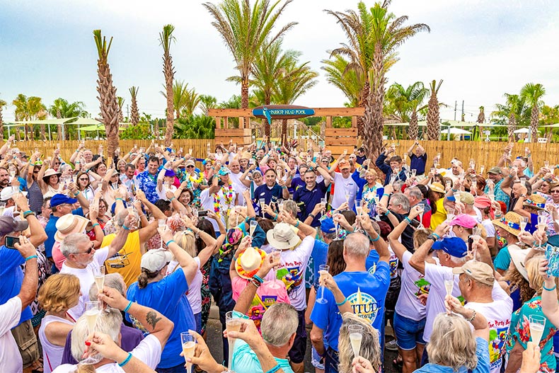 Group of people toasting to the opening of Latitude Margaritaville in Daytona Beach, FL
