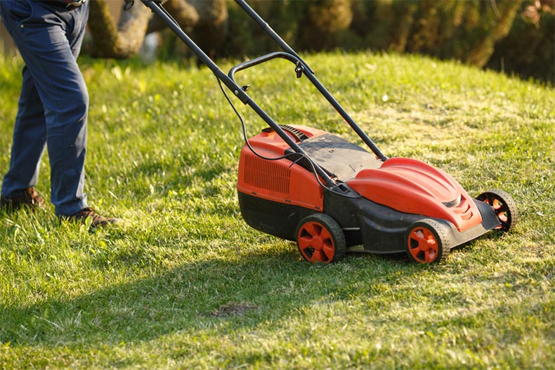 A landscaper mowing lawns for residents of a 55+ community