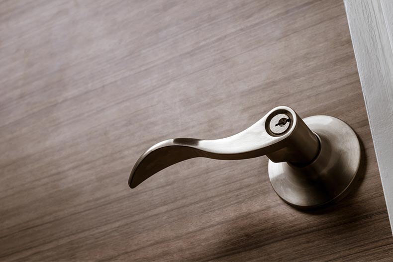 A wave style lever handle front door knob with lock
