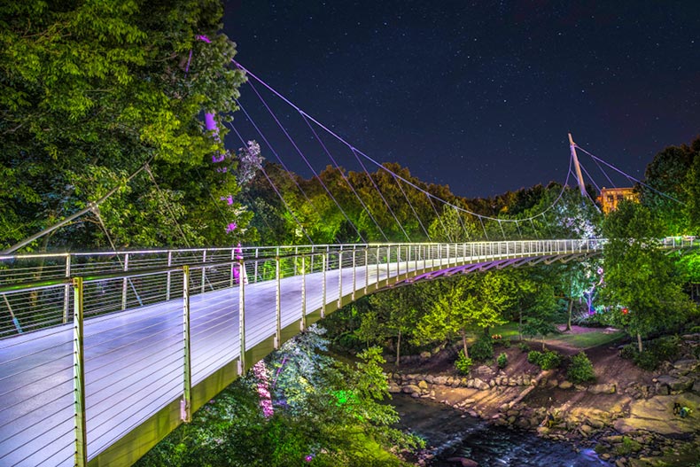 The illuminated Liberty Bridge in Falls Park in Downtown Greenville, South Carolina
