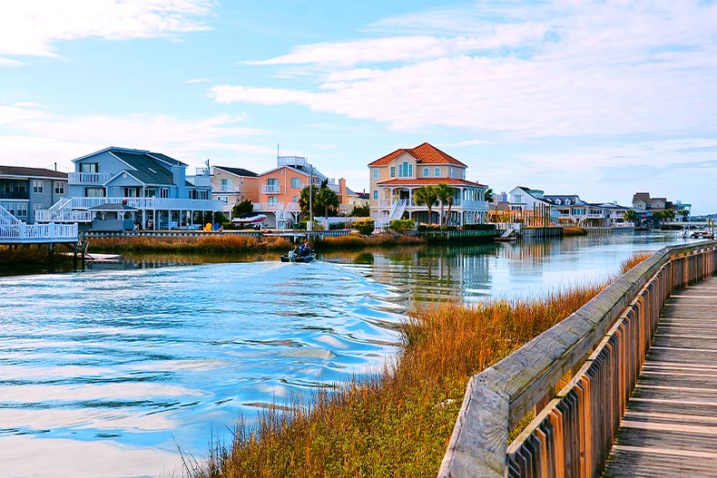 Photo of a river with homes and a wooden path lining the bank located in North Myrtle Beach, South Carolina