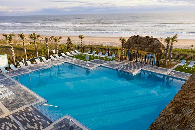 Aerial view of the outdoor pool beside the beach at the private beach club at Latitude Margaritaville in Daytona Beach, Florida