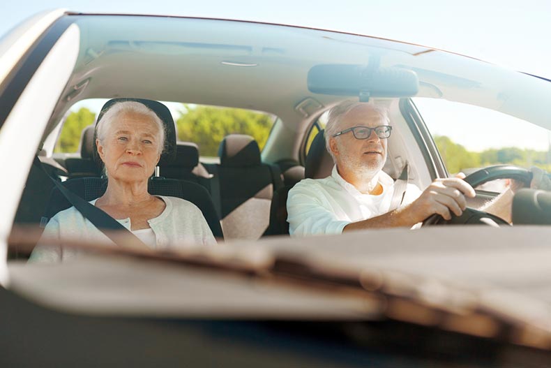 An older couple on a long drive into town