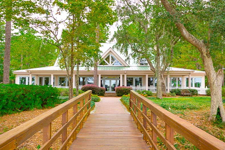 Exterior view of a wooden walkway leading to an amenity center at Sun City Hilton Head in Bluffton, South Carolina