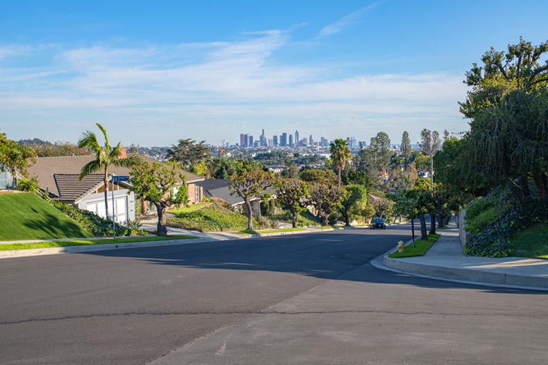 A Los Angeles residential street with the Downtown Los Angeles skyline in the background