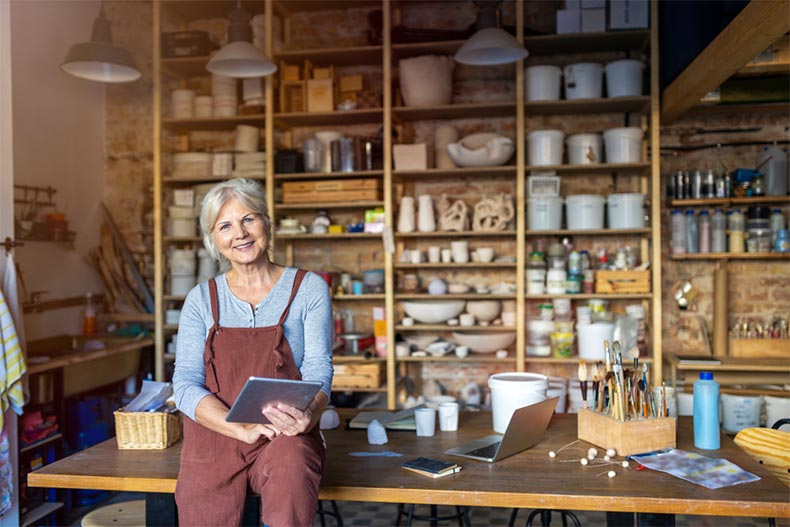 Older woman sitting in a pottery studio