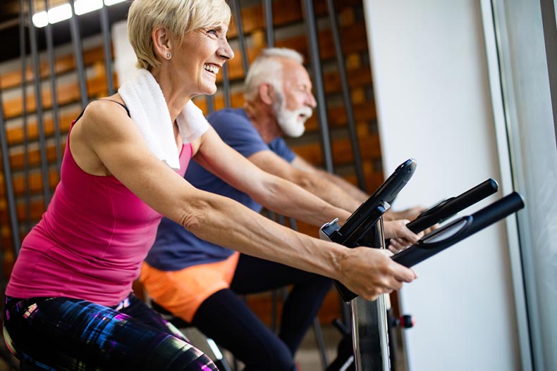 A mature couple exercising in the gym to stay healthy