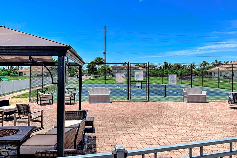 Lounge chairs beside the outdoor pickleball courts at Mirabella in Bradenton, Florida
