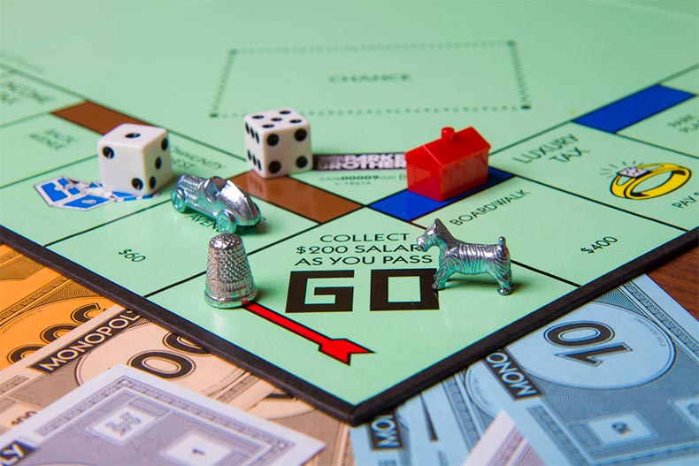 Close up a Monopoly board and game pieces