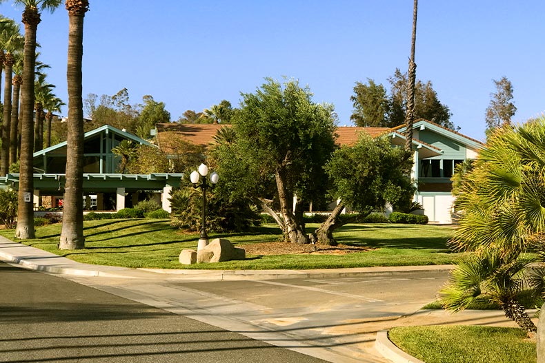 Exterior view of the clubhouse at Murrietta Hot Springs in Murrietta, California surrounded by different species of trees