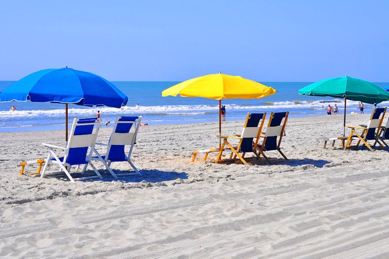 A row of beach chairs waiting for sun bathers
