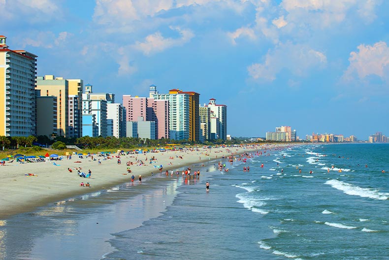 Myrtle Beach, South Carolina shoreline with beachgoers and the city skyline