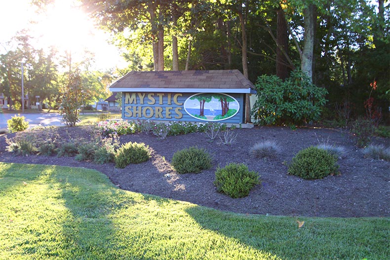 Manicured greenery surrounding the community sign for Mystic Shores in Little Egg Harbor, New Jersey