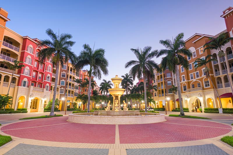 Naples, Florida town skyline and city plaza at twilight.