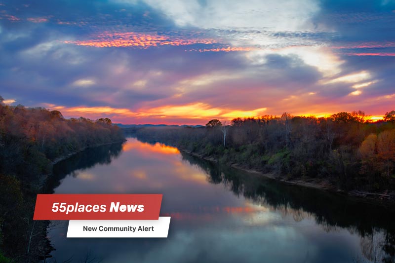 "New Community Alert" banner over the Cumberland River at dusk