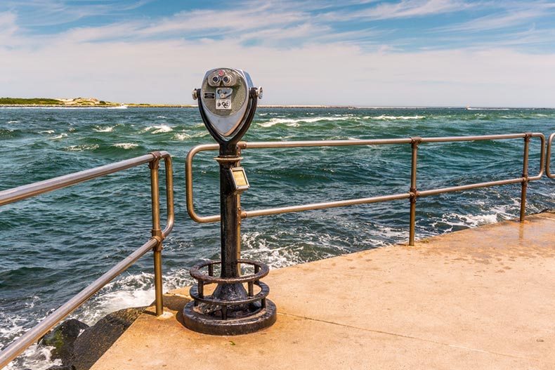 A viewer on an observation deck overlooking the Barnegat Inlet in New Jersey