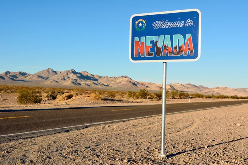 A "Welcome to Nevada" road sign along a highway