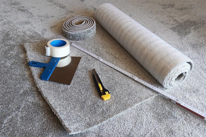 Tools on top of a roll of new carpet