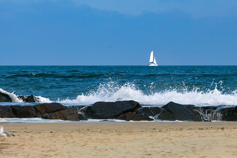 A single white boat on the horizon of choppy waters in Ocean County, New Jersey