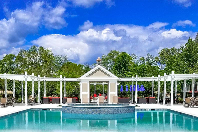 Lounge chairs beside the outdoor pool at Nobility Crest at Ocean in Ocean Township, New Jersey