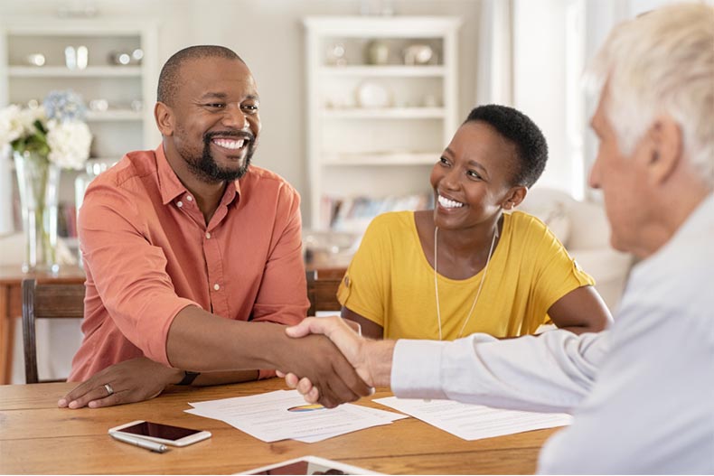 A senior couple meeting with a financial advisor to plan for their retirement