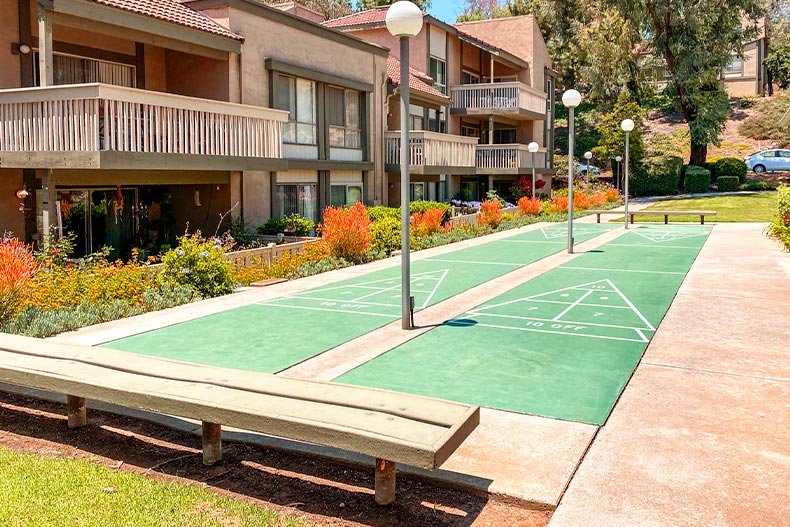 Two shuffleboard courts in a courtyard in front of a condo building located in the Oaknoll Villas community of Thousand Oaks, California
