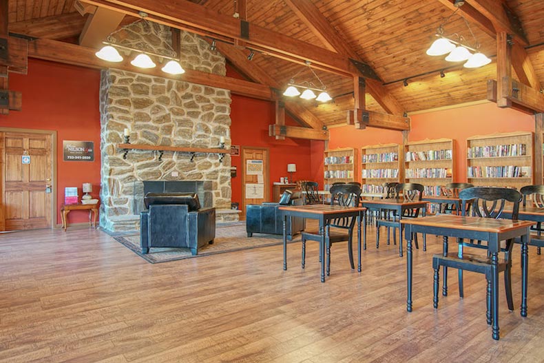 A rustic library with a fireplace at Holiday City at Berkeley in Toms River, New Jersey