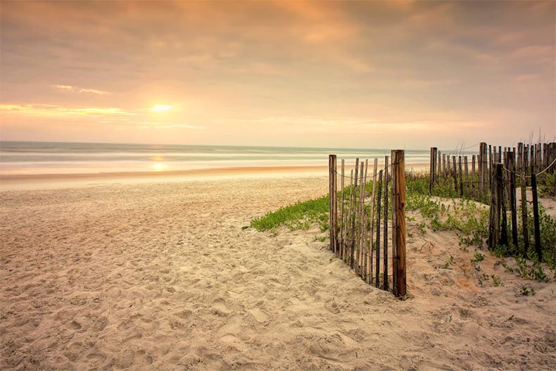 A wooden fence along the shore of Ormond Beach in Florida