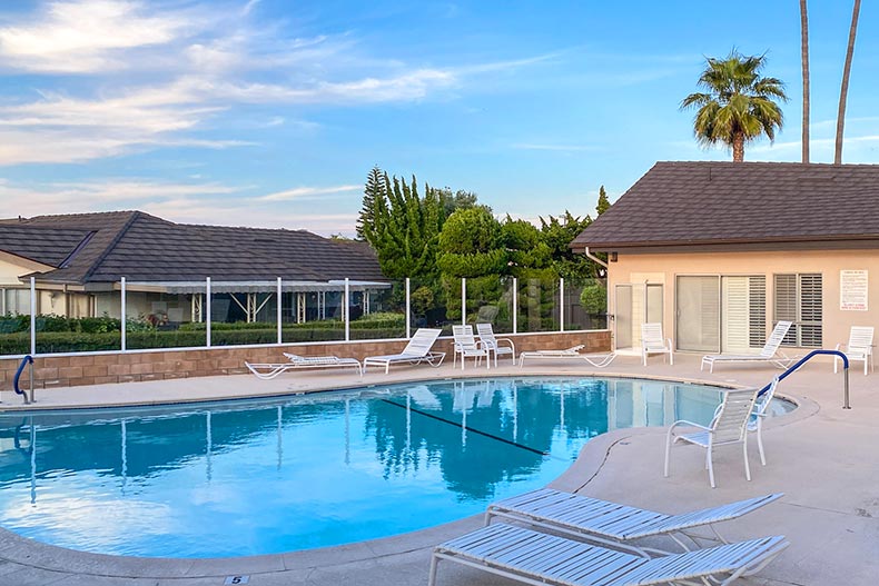 Lounge chairs beside the outdoor pool at New Horizons South Bay in Torrance, California