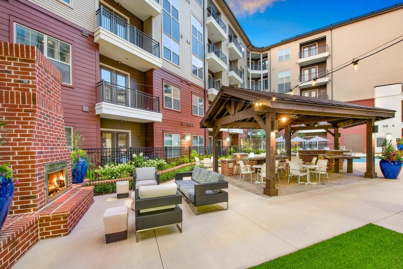 Lounge chairs and tables on an outdoor patio at Overture Buckhead South in Atlanta, Georgia