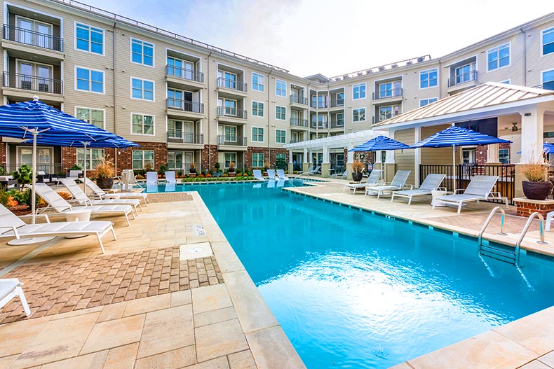 The outdoor pool surrounded by patio chairs at Overture Crabtree in Raleigh, North Carolina