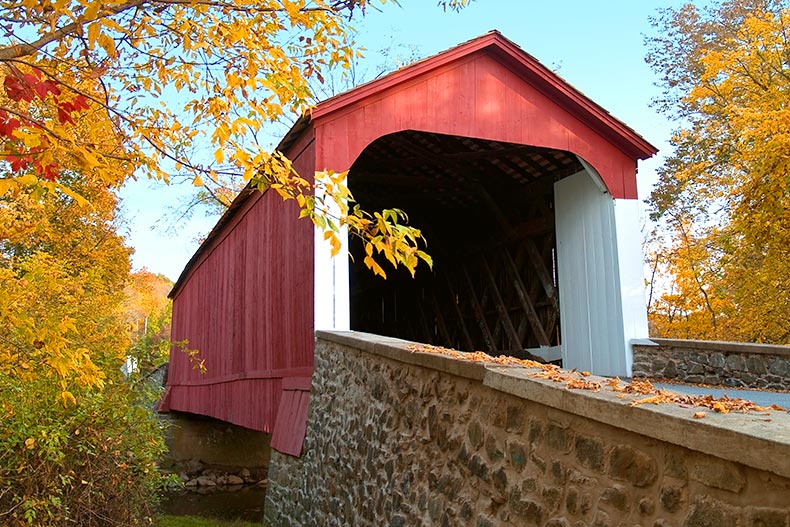 A covered bridge surrounded by autumn trees in Bucks County, Pennsylvania