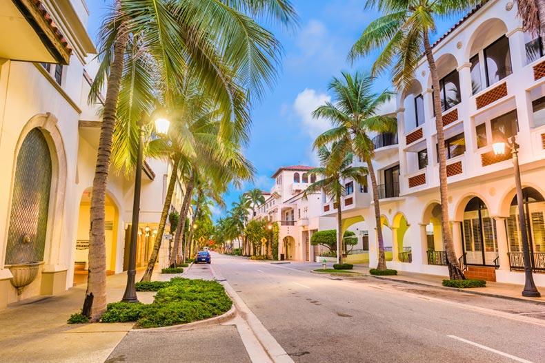 Palm trees lining Worth Ave at twilight in Palm Beach, Florida