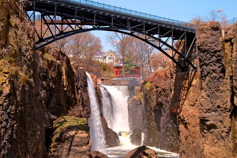 Waterfall flowing into the Passaic River in Paterson, New Jersey with a bridge overhead