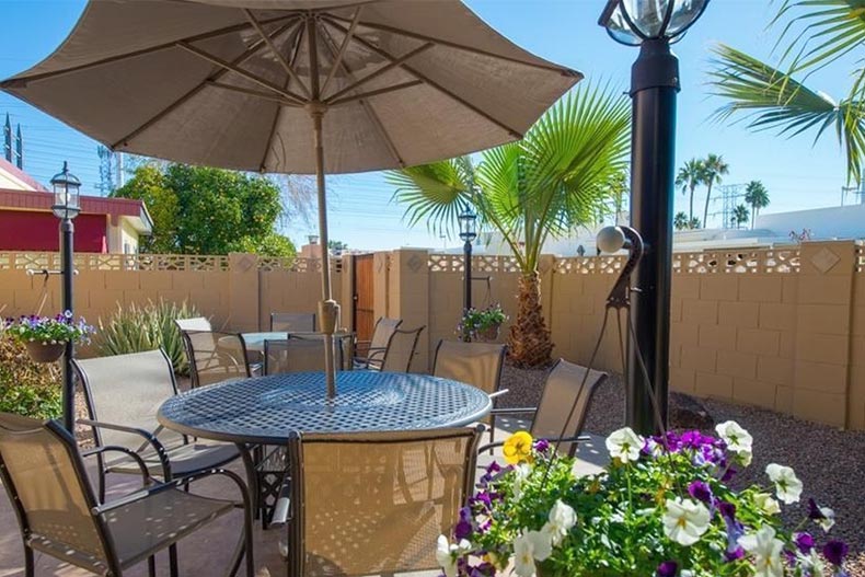 Patio chairs and tables in a fenced-in yard at Golden Keys in Scottsdale, Arizona