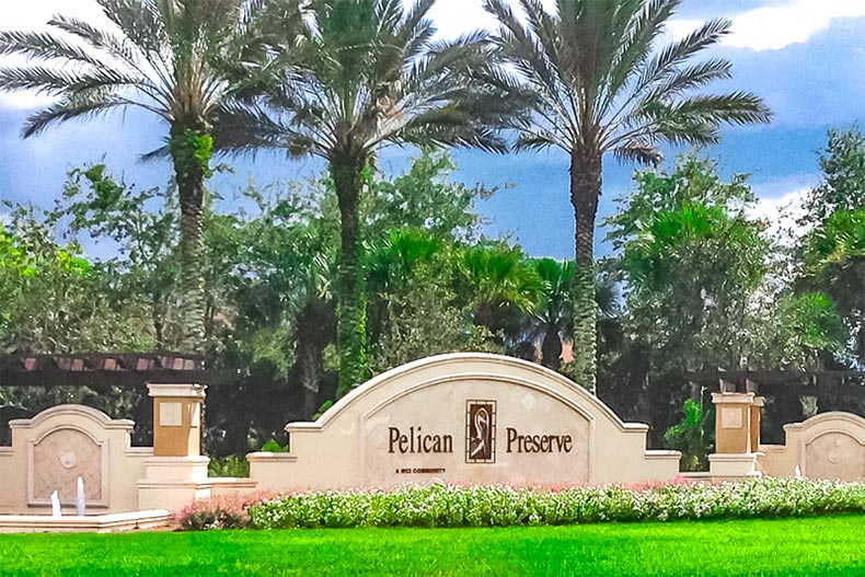 Palm trees surrounding the community sign for Pelican Preserve in Fort Myers, Florida