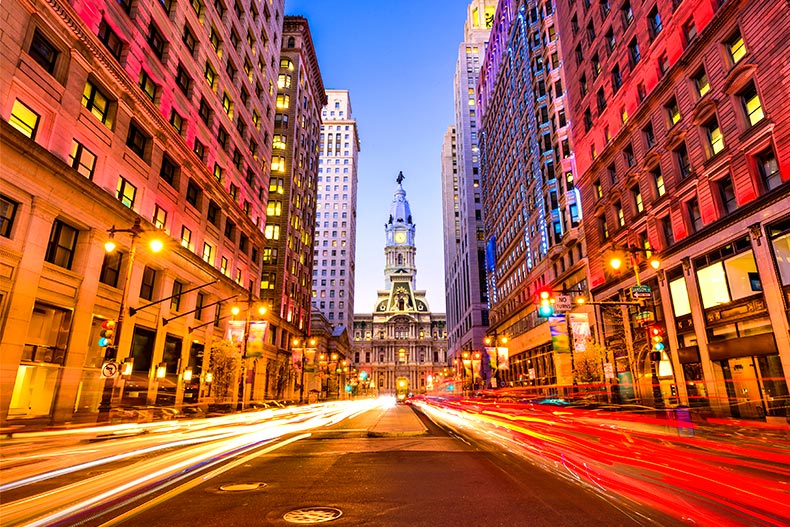 A Philadelphia, Pennsylvania street at dusk with long exposure car lights and the city hall at the end