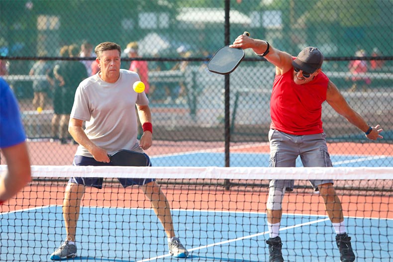 Two senior men playing doubles pickleball