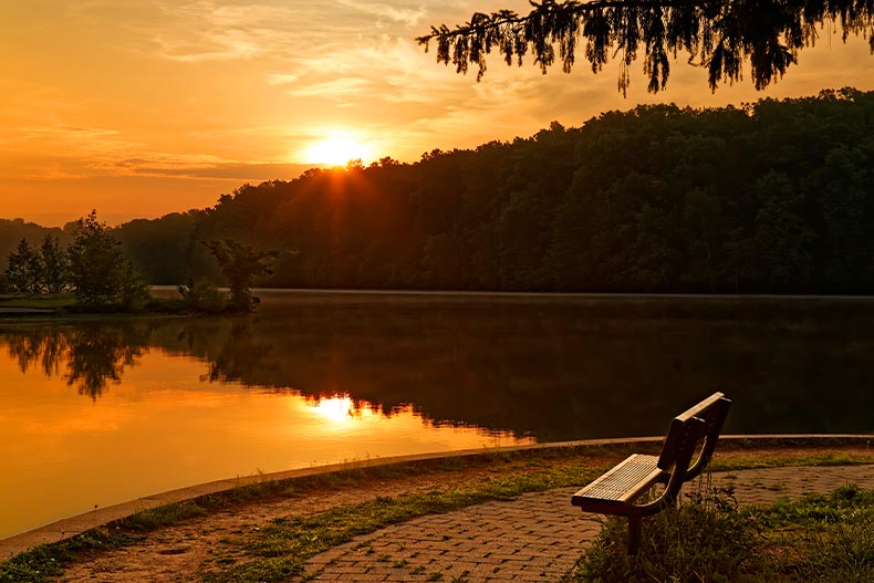  View of a park bench overlooking a river at sunset, located in Gifford Pinchot State Park, Pennsylvania