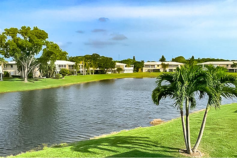 Homes surrounding a picturesque pond in The Pines Of Delray in Delray Beach, Florida